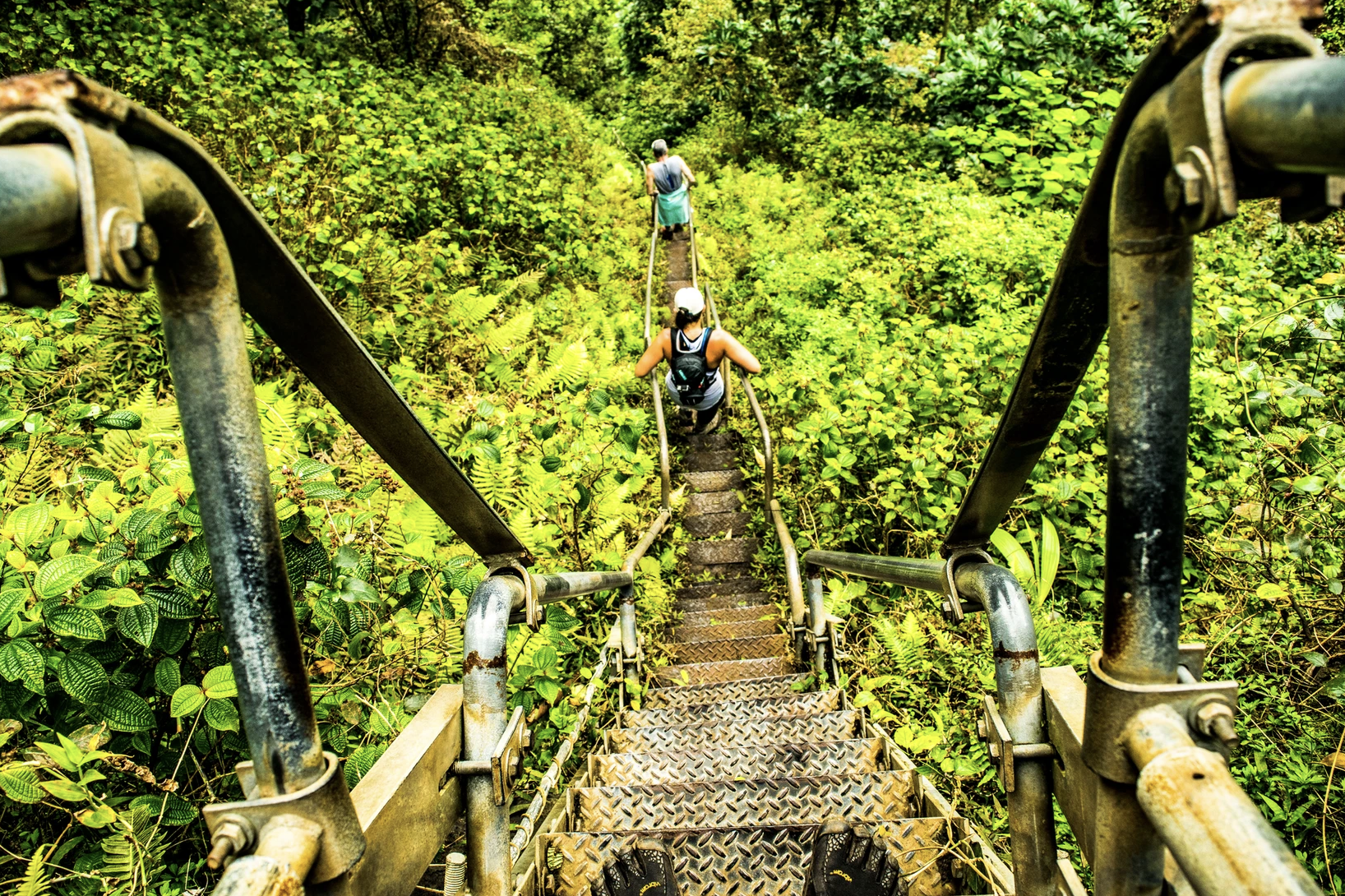 Hikers descend the Haiku Stairs on Oahu.