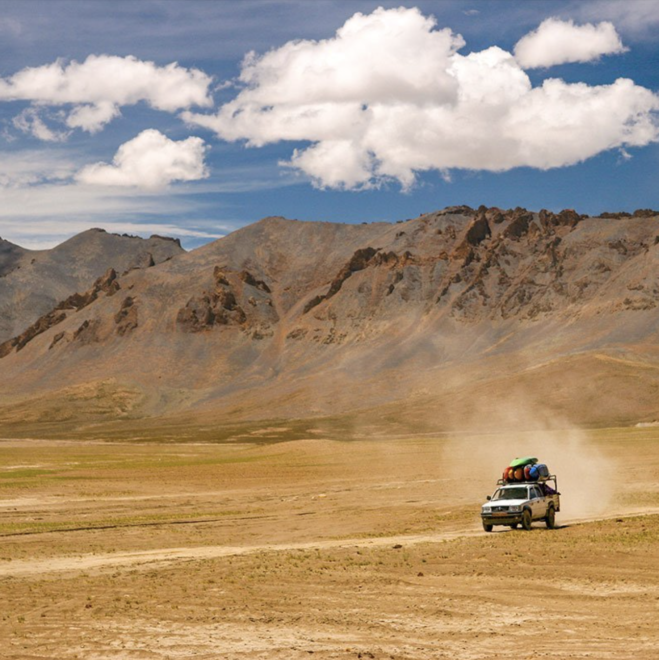 a 4X4 car driving across a desert