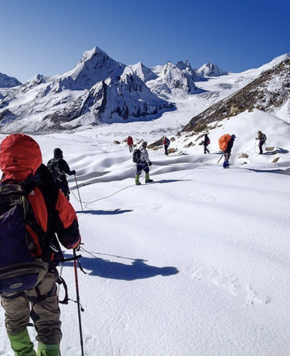 trekkers in a snowy alpine environment