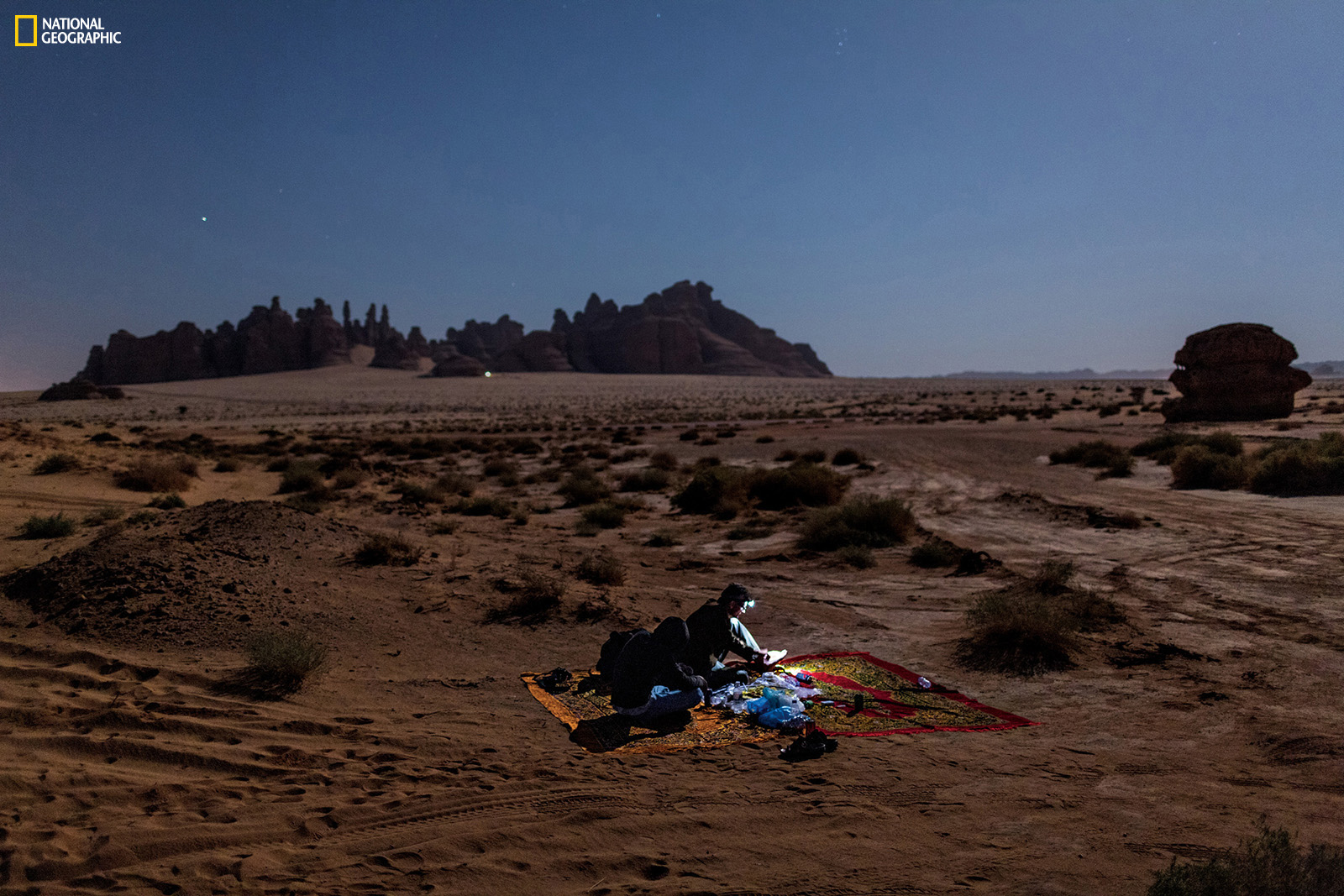 Surrounded by the ghosts of travelers who came before him, author Salopek camps amid 2,000-year-old Nabataean tombs at Madain Salih. Join the journey at outofedenwalk.org. Photograph by John Stanmeyer / National Geographic 