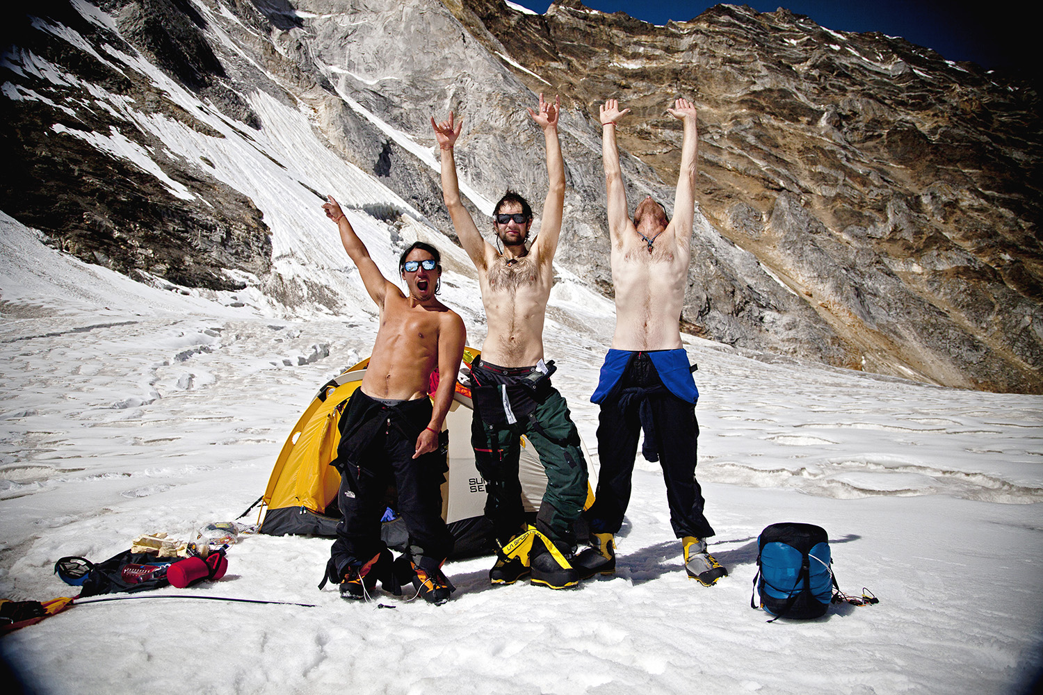 Jimmy Chin, Renan Ozturk and Conrad Anker rejoice after 12 days on the route. The descent is often the most dangerous part of climb. After two days of rappelling through severely overhanging rock, down rock strafed gullies and the final lower alpine ice wall, the team is finally able to take in their accomplishment.