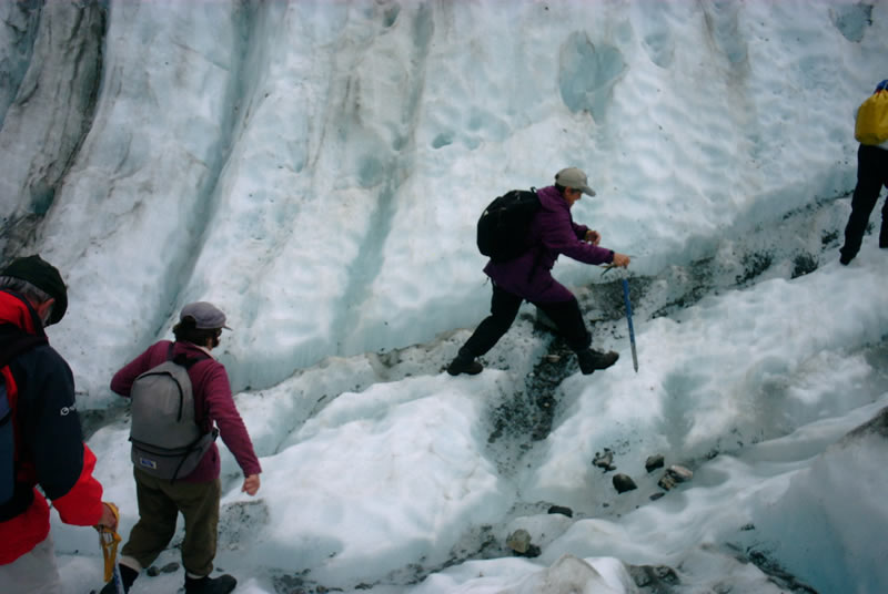 30-new zealand-doann crossing a crevasse on a glacier-it doesn't look deep but it was