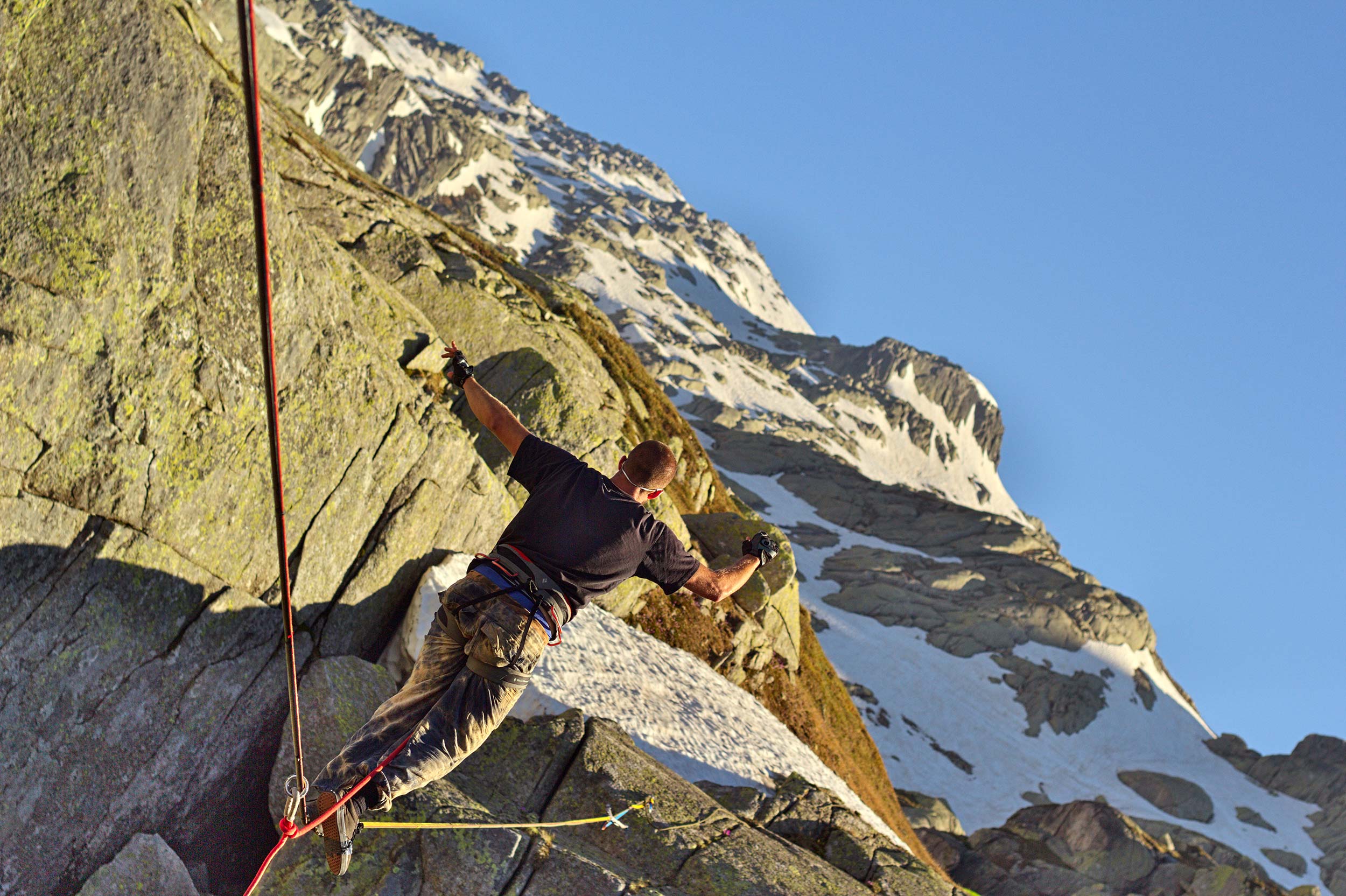 Matthias Bleisch finally walking on a 30mm webbing tied between two rock faces with a deep gorge of river and stones below him. Photo: Trivik Verma