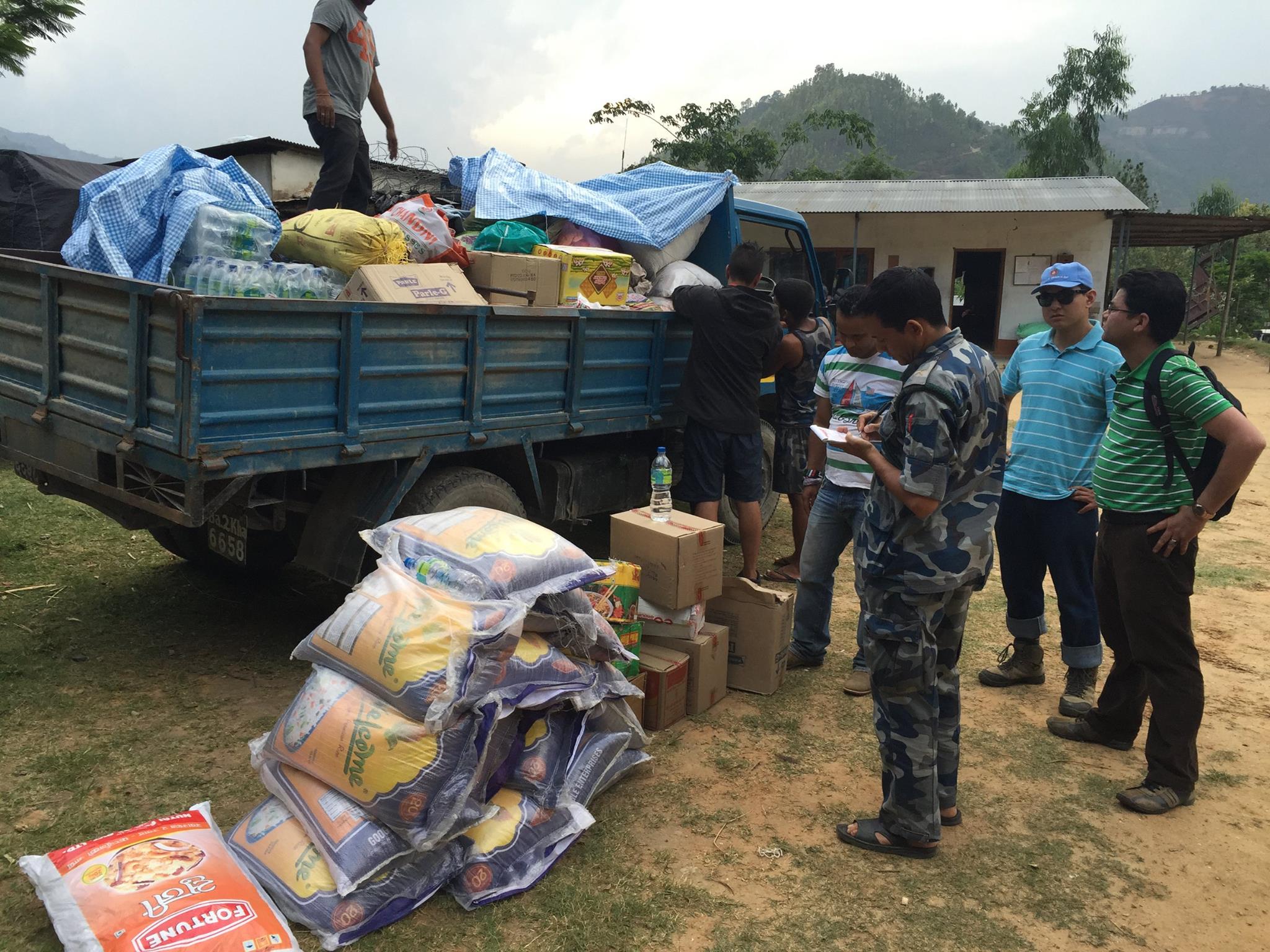 Food for Relief team allotting relief materials for people affected at Mulabari, Kalleri VDC, Dhading under the coordination of the Armed Police Force at their camp