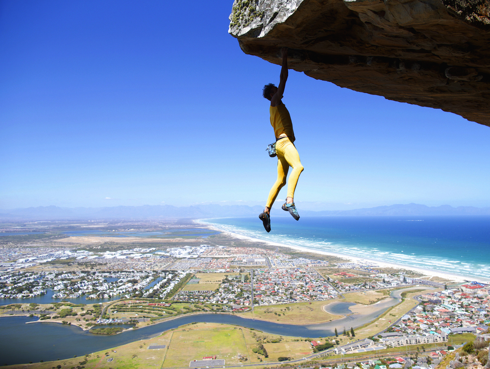 Dancing on the Ceiling (5.11d/7a). Hanging five on the first free solo ascent of ‘Dancing on the Ceiling’ (5.11d/7a). Muizenburg. Cape Town. Photographer: Stefan Grey. 