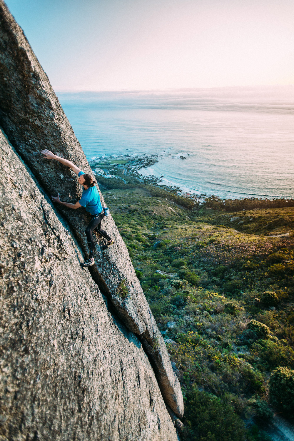Lion Heart (5.11b/6c). Reaching the top on the first free solo ascent of Lion Heart. Lion’s Head. Cape Town. Photo: Micky Wieswedel.