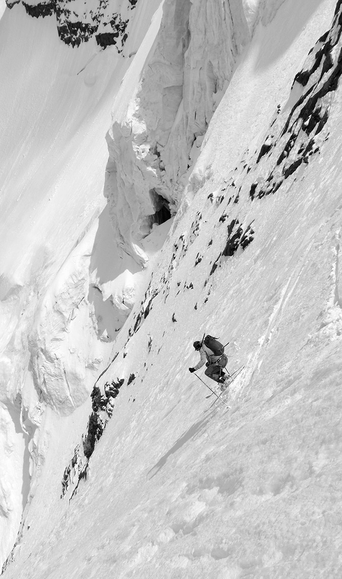 Adelin on the mid section under the upper seracs. A few moments before I heard "clong clac" from the seracs. This noise made me a bit more concerned so then we adopted the technic "one skis, the other one watch the seracs." © Sébastian de Sainte Marie 