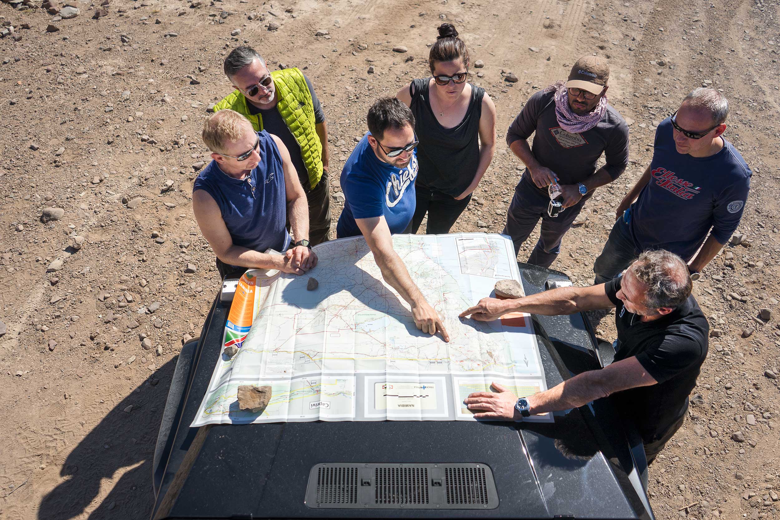 The group gathers around a map to figure out where we are today and where exactly we're headed. The drive was mostly an unplanned adventure, with Mike taking what appeared to be new and arbitrary decision about the route daily. Photo: Apoorva Prasad