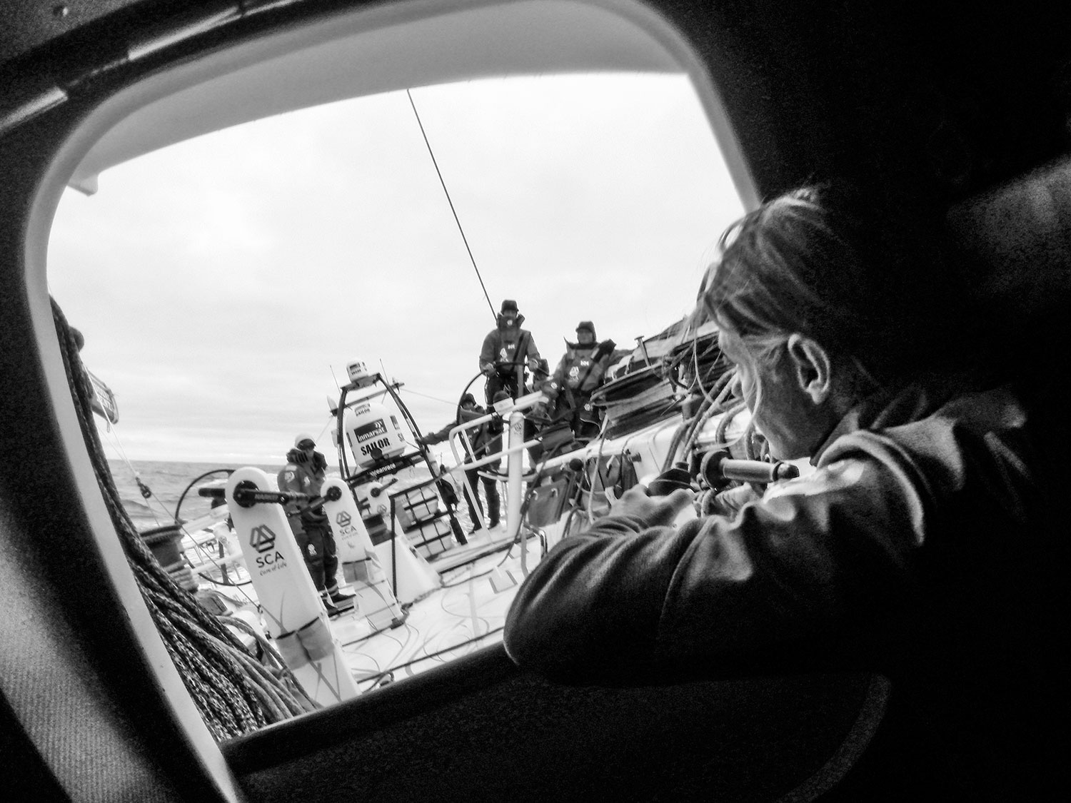 Liz Wardley looks out the hatch before her watch begins. PHOTO: CORINNA HALLORAN / TeAm SCA / VOLVO OCEAN RACE