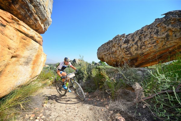 Ancient rock formations of the Kouebokkeveld region create an interesting landscape for competitors. Here, 2016 winner, Urs Huber, negotiates his way through Stage 1 singletrack. Photo credit: www.zcmc.co.za
