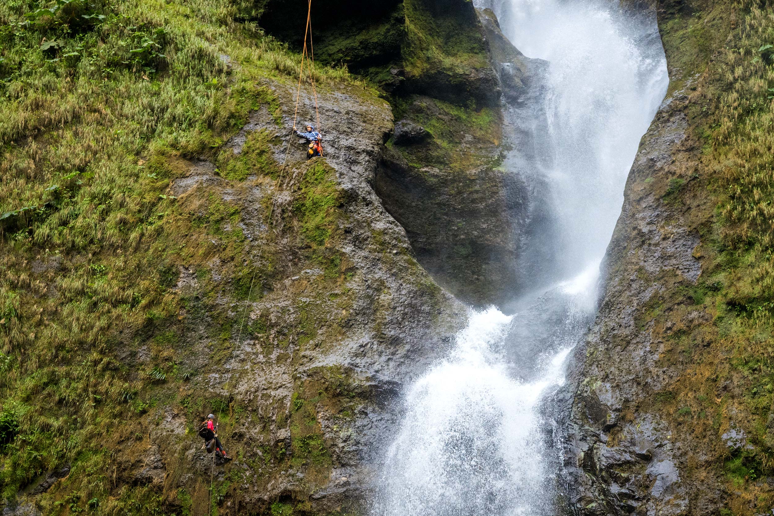 Eyleen rappels down the last segment of the multi-pitch, as Johan (above) prepares to switch ropes mid-descent. Photo by: Victor Hugo Carvajal